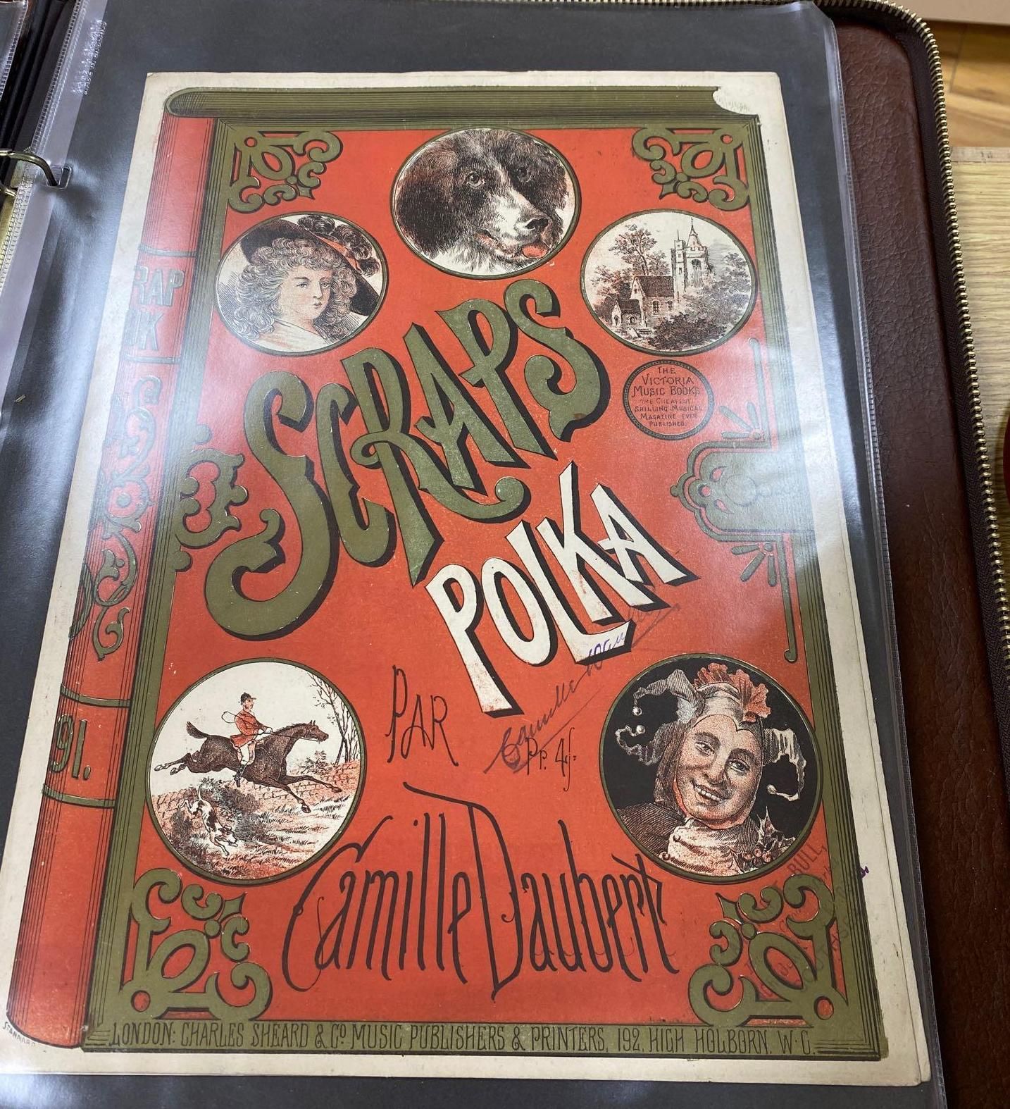 A collection of printed ephemera, including a folio of Victorian decorative sheet music covers,